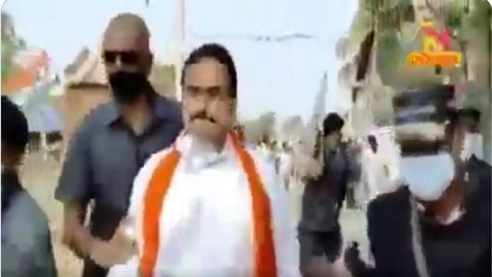 The video shows a politician, escorted by security personnel, being chased by angry villagers. | Twitter screenshot