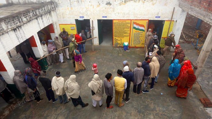 Voters queue up at a polling booth in Nethla village, Baghpat district, during the first day of voting for the 2022 UP assembly elections, Thursday | Praveen Jain | ThePrint