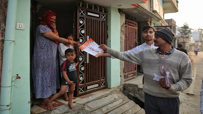RSS workers distribute pamphlets about electoral issues in Moharipur, a village in UP's Gorakhpur district | Suraj Singh Bisht | ThePrint