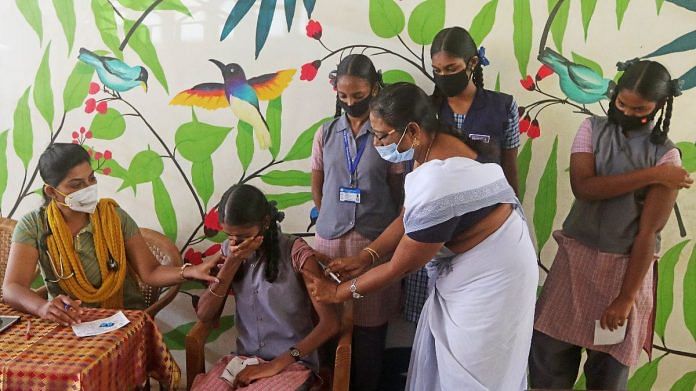 A healthcare worker inoculates a dose of the Covid-19 vaccine to a girl at Government Higher Secondary School in Chennai, on 25 February 2022 | ANI photo