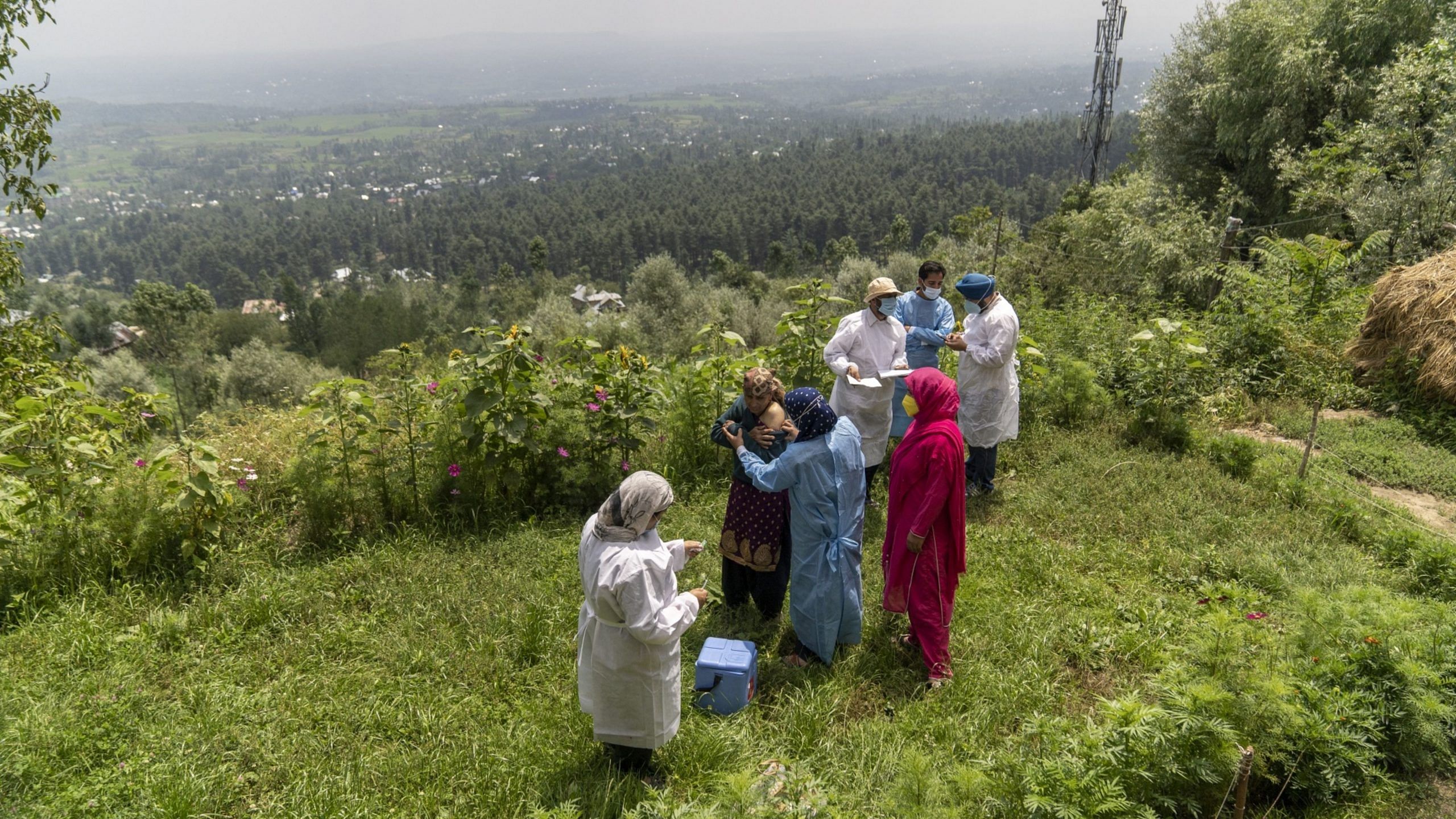 A “door-to-door” vaccination team inoculates residents at a village in the Budgam district of Jammu and Kashmir, India, in August 2021. Photographer: Sumit Dayal/Bloomberg