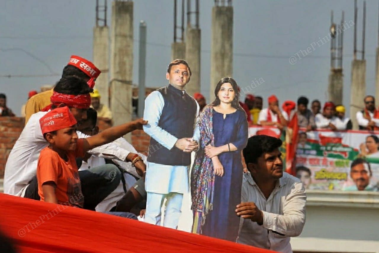 A supporter holds cut out of Akhilesh Yadav and his wife Dimple Yadav | Photo: Praveen Jain | ThePrint