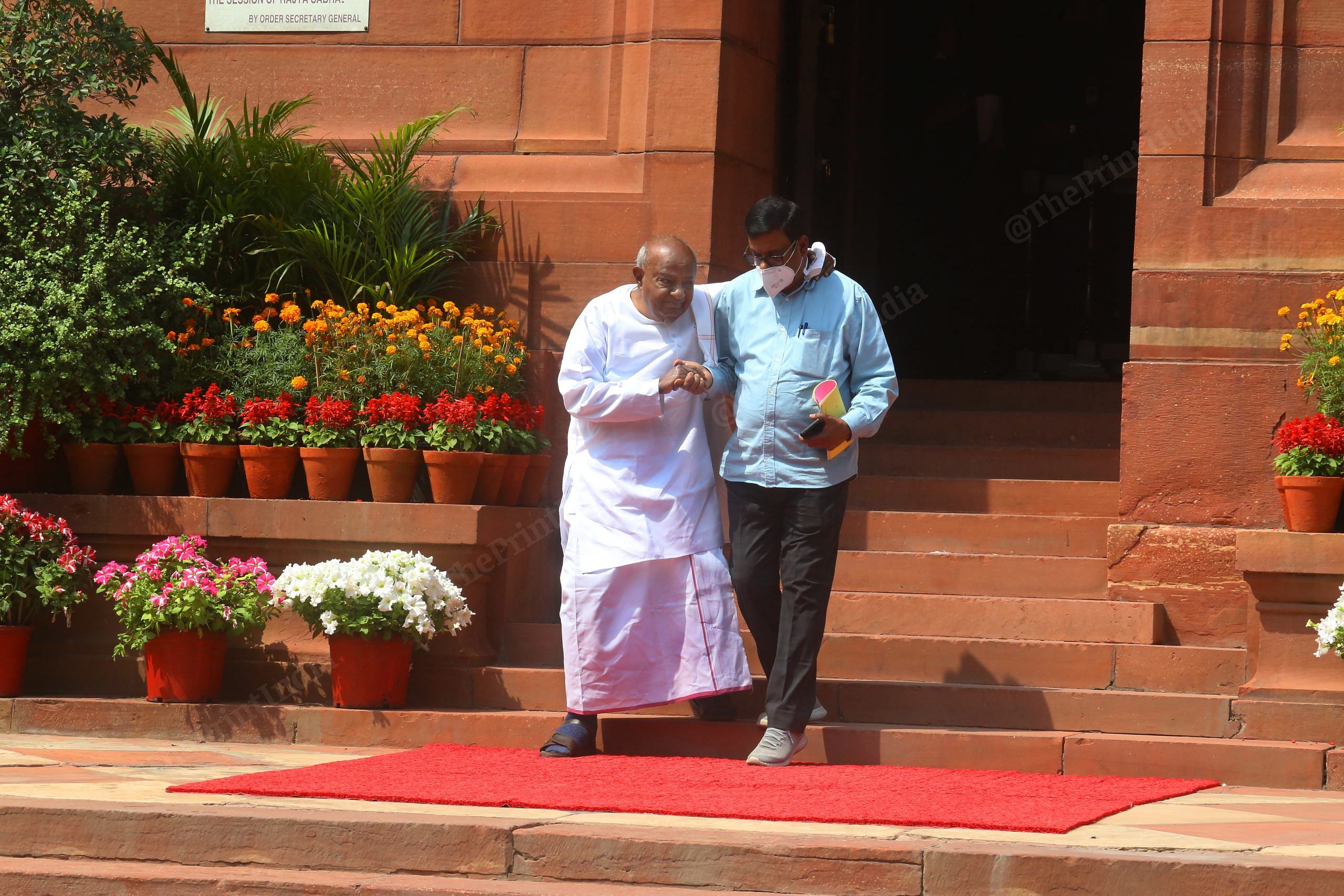 Former PM H.D. Deve Gowda is helped down the Parliament stairs | Photo: Praveen Jain | ThePrint