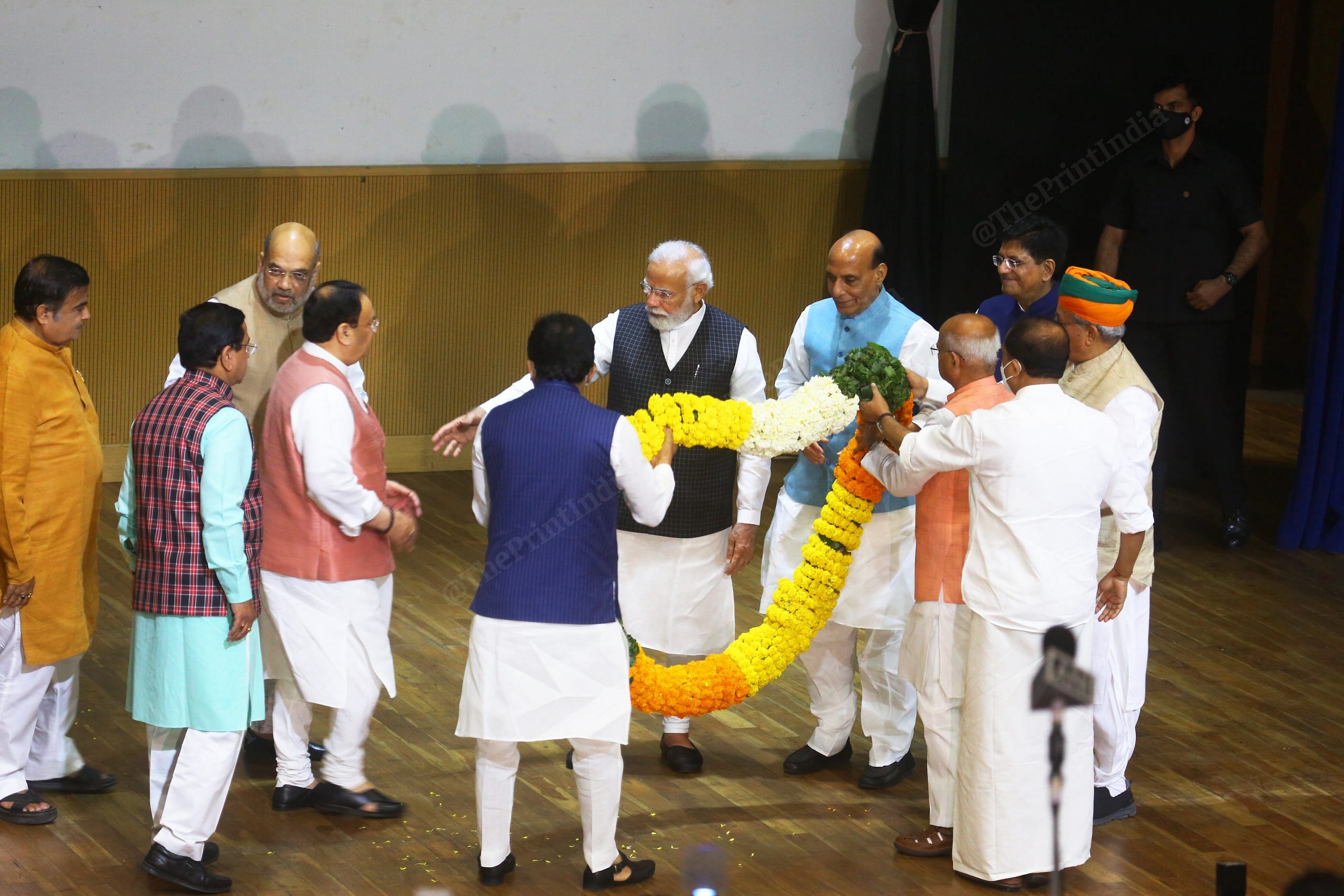 PM Modi asks party President J.P. Nadda to join him as he is garlanded | Photo: Praveen Jain | ThePrint
