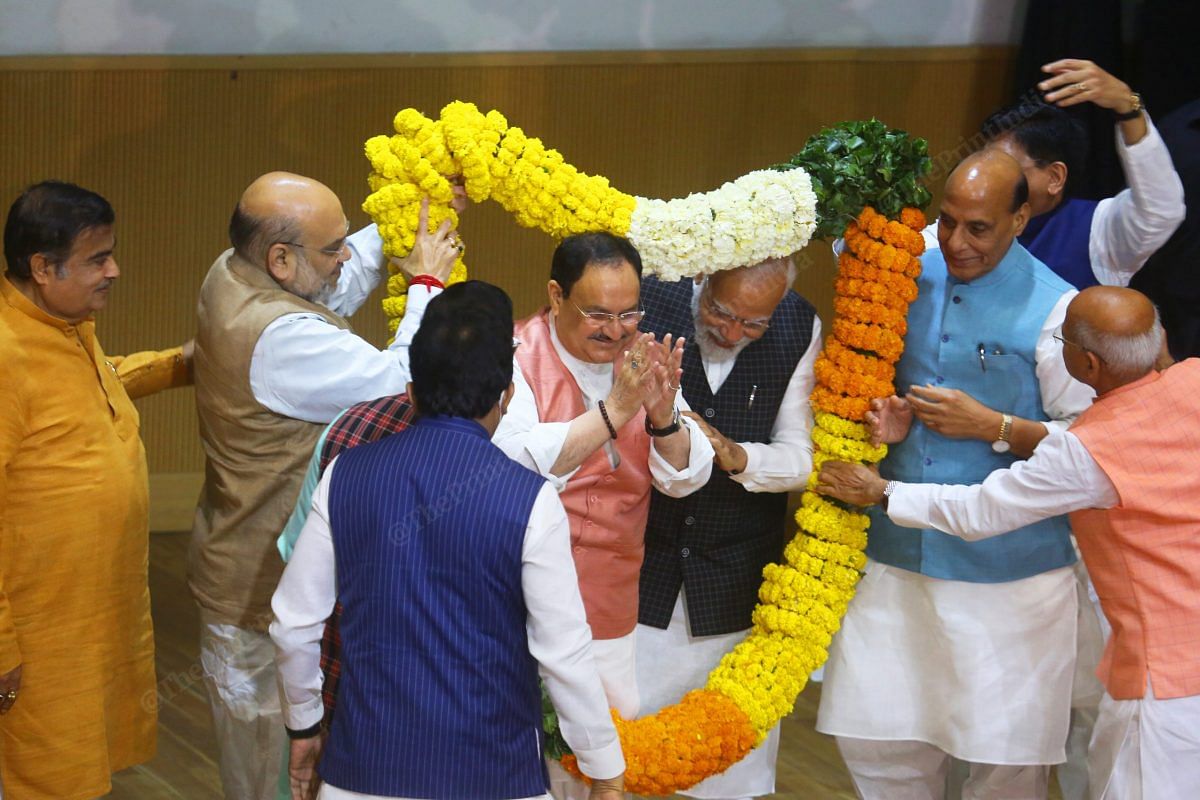 PM Modi pushes J.P. Nadda ahead of him for the garlanding | Photo: Praveen Jain | ThePrint