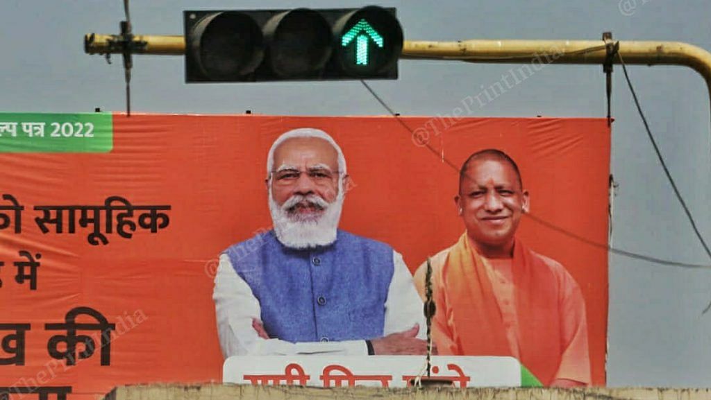 A giant hoarding of Prime Minister Narendra Modi and Chief Minister Yogi Adityanath at a traffic signal in Varanasi | Praveen Jain | ThePrint