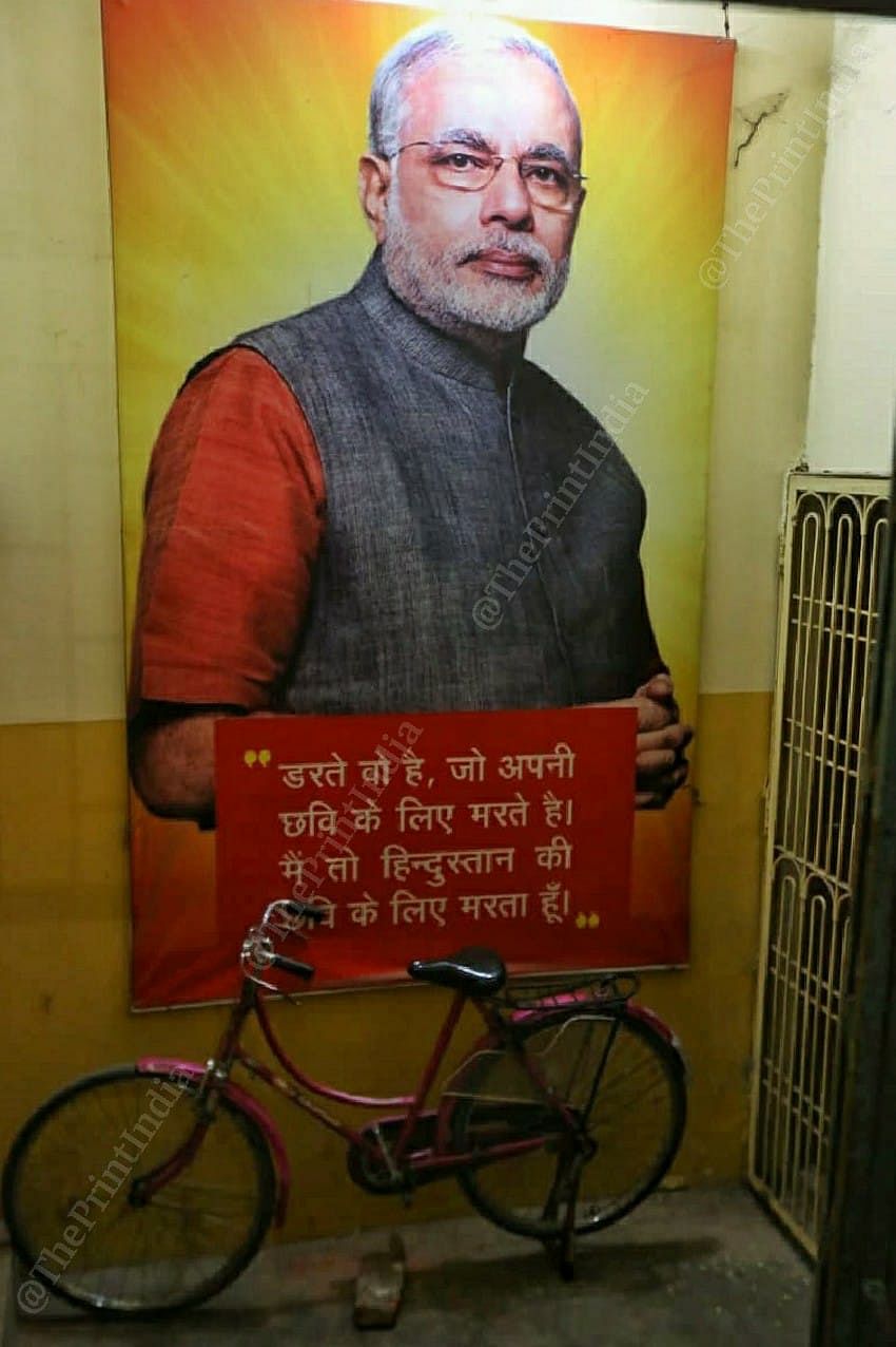 At BJP war room in Varanasi, a cycle is kept inclined on PM Modi's posters | Photo: Praveen Jain | ThePrint