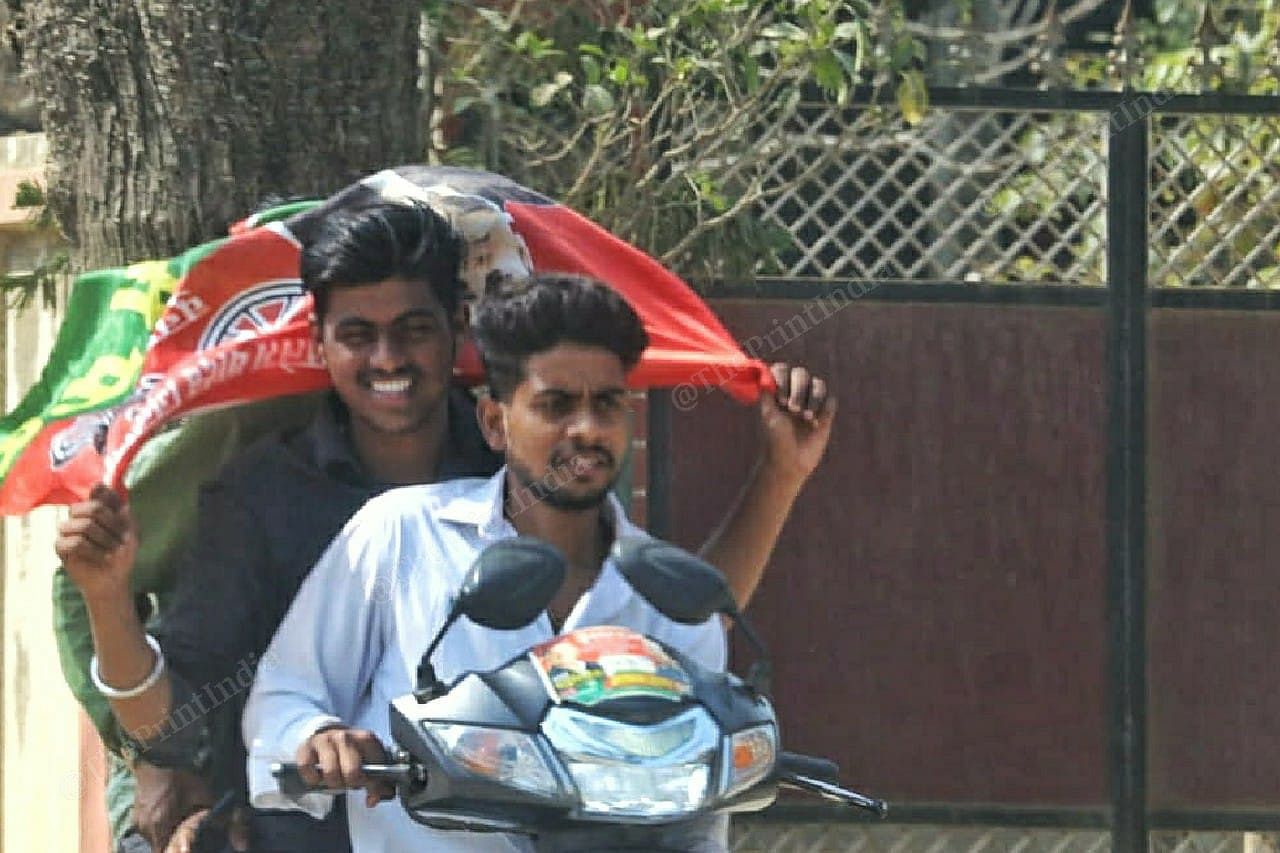 Two youngsters carry the SP flag | Photo: Praveen Jain | ThePrint