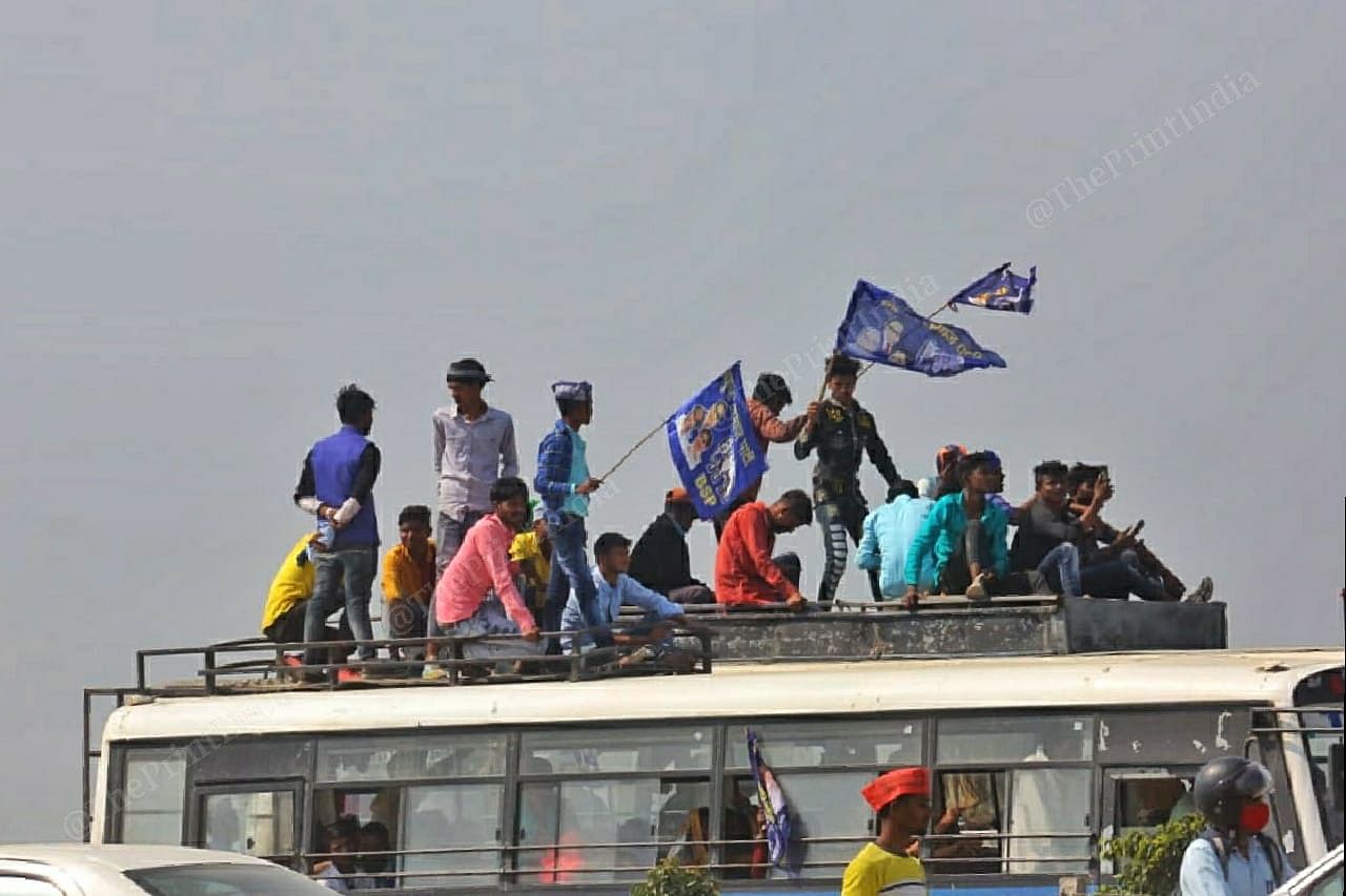 Supporters of BSP stand on bus's roof | Photo: Praveen Jain | ThePrint