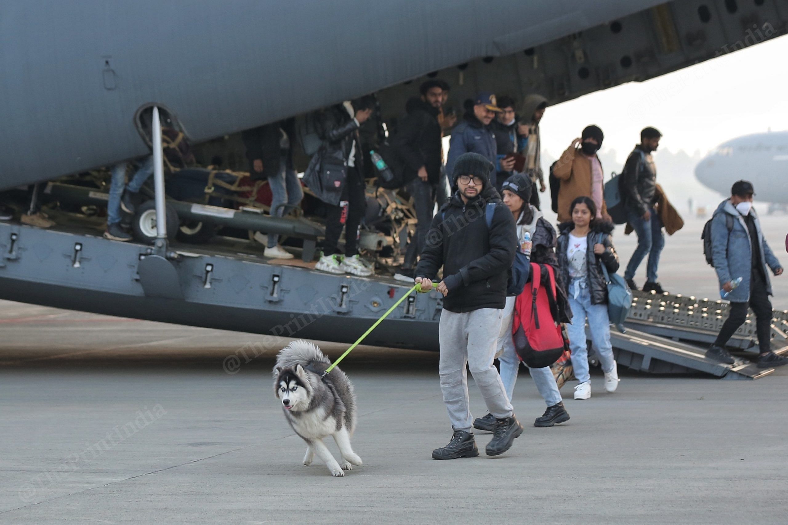 Stranded students seen with Dog Neela upon arriving from Poland at the Hindon Airbase in Ghaziabad | Photo: Suraj Singh Bisht | ThePrint