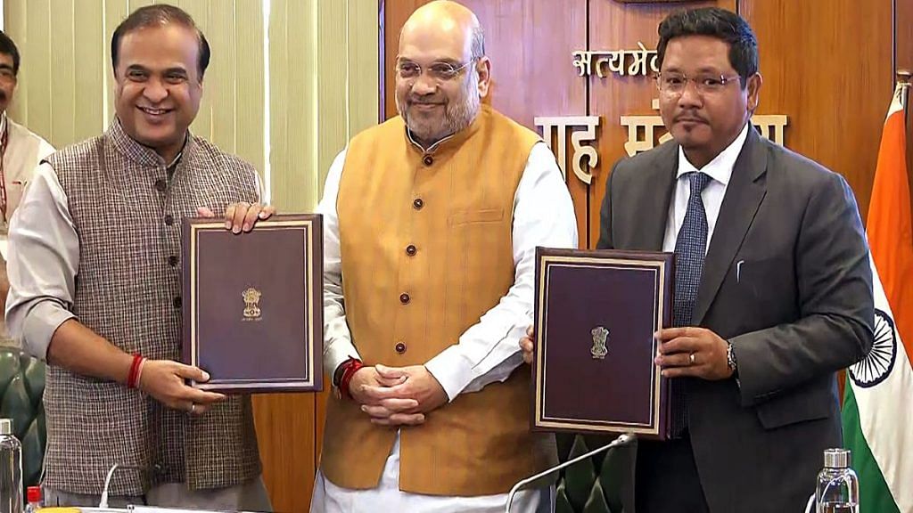 Assam CM Himanta Biswa Sarma and Meghalaya CM Conrad Sangma with Union Home Minister Amit Shah, after signing an agreement to resolve the 50-year-old boundary dispute between their states, in New Delhi on 29 March 2022 | ANI