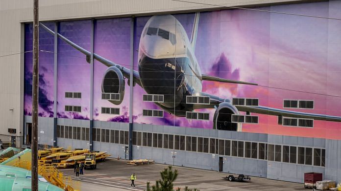 Representational image | A worker walks under a mural of a Boeing Co. 737-800 airplane outside the company's manufacturing facility in Renton, Washington | Photo: David Ryder | Bloomberg