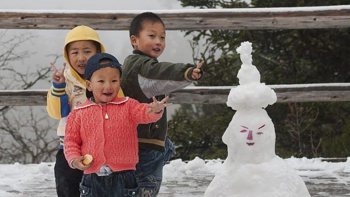 Three Chinese boys posing in front of their snowman in Huanglong, Sichuan, China. | Representative Image. | Photo Credit: Wikimedia Commons