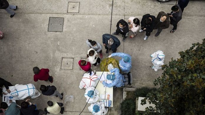 Residents line up to receive rapid antigen test kits for Covid at a neighborhood in Shanghai, on 26 March 2022 | Representational image | Bloomberg