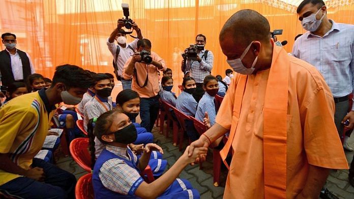 Uttar Pradesh CM Yogi Adityanath greets a student at the launch of the Covid vaccination drive for the 12-14 years age group in Lucknow, on 16 March 2022 | ANI photo