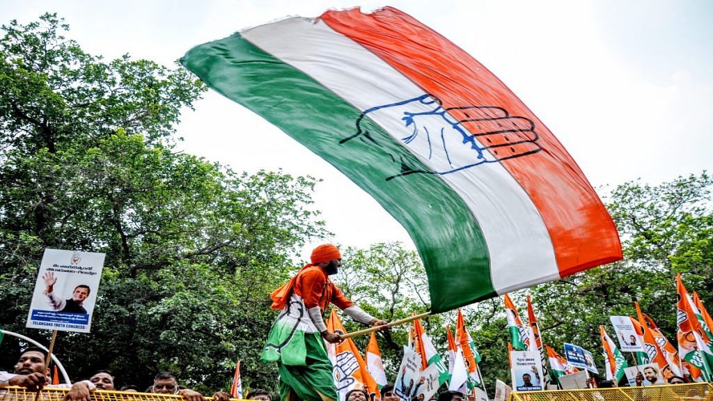 File photo of a Congress worker waving the party flag | ANI