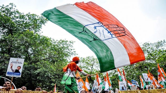 File photo of a Congress worker waving the party flag | ANI