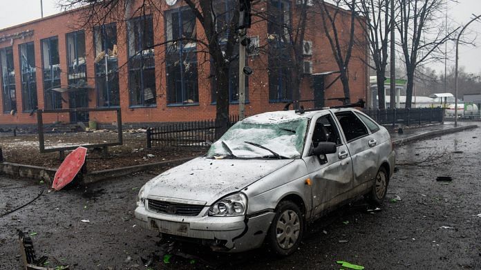 A damaged vehicle parked near destroyed buildings following Russian missile strikes in Kyiv on 2 March 2022 | Photo: Erin Trieb | Bloomberg
