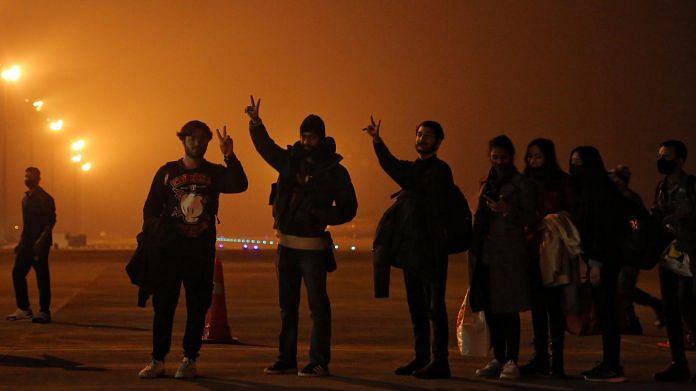 Indian students evacuated from war-hit Ukraine flash the victory sign after arriving at Hindon airbase in Ghaziabad, Uttar Pradesh | Suraj Singh Bisht | ThePrint