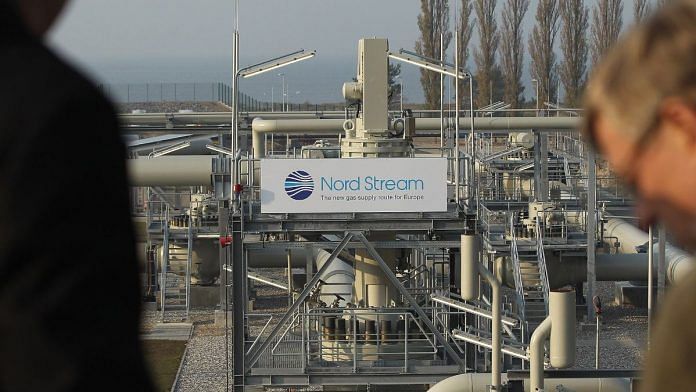 Visitors look out at the central facility where the Nord Stream Baltic Sea gas pipeline reaches western Europe following the pipeline's official inauguration in Lubmin, Germany | Bloomberg
