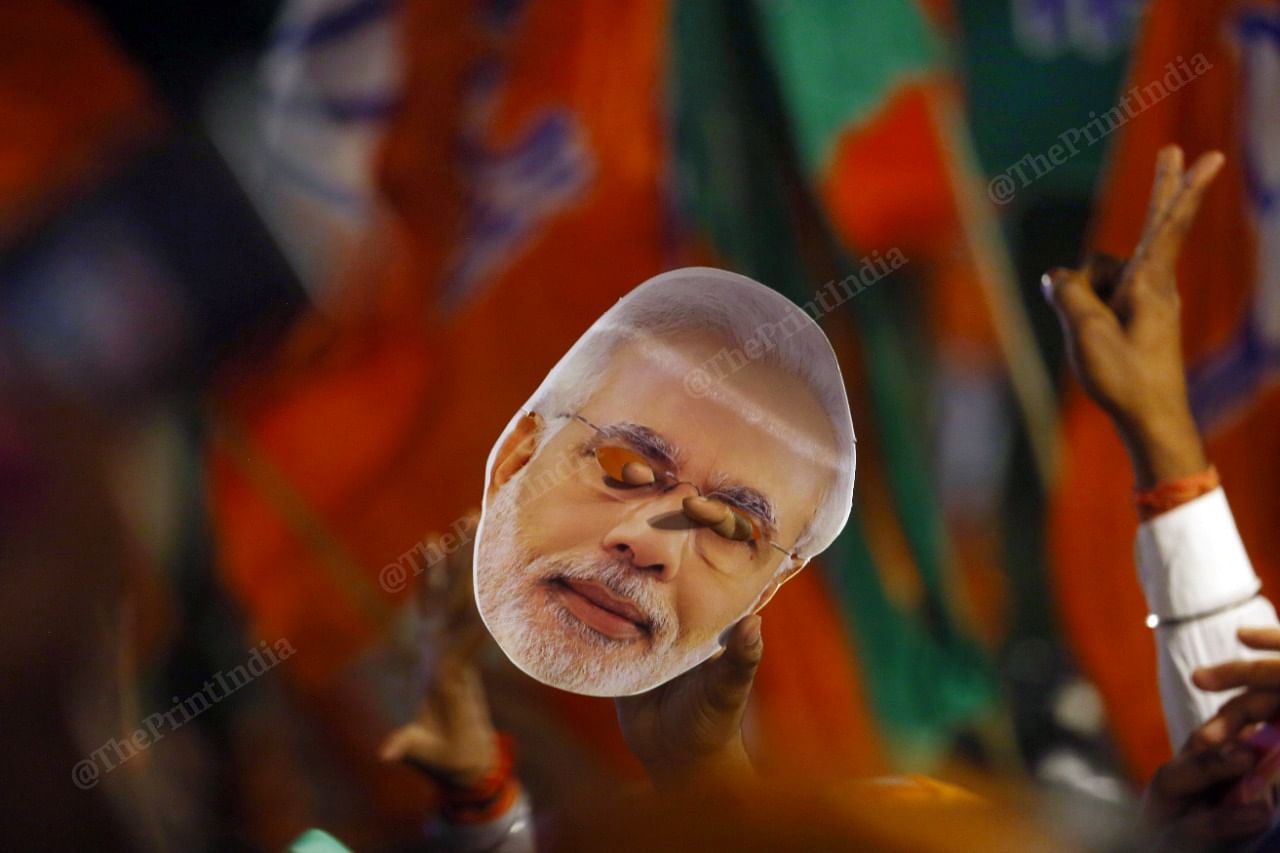 BJP's four-state election victory is a revalidation of the power of 'Brand Modi'. A supporter pays homage by holding up a 'Modi mask' | Photo: Praveen Jain | ThePrint