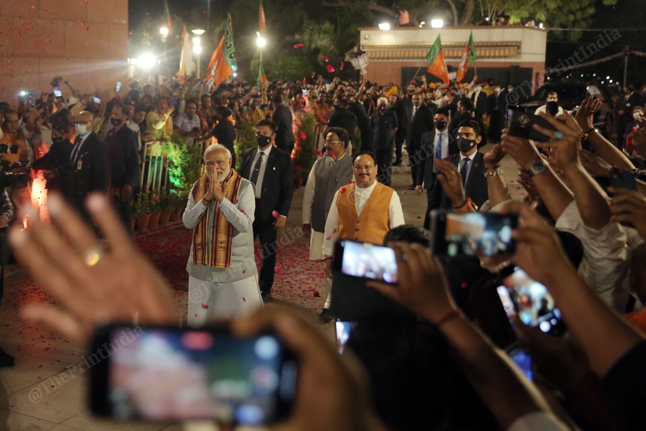 The gathered crowd cheer as PM Modi and BJP President J.P. Nadda enter the party office | Photo: Suraj Singh Bisht | ThePrint