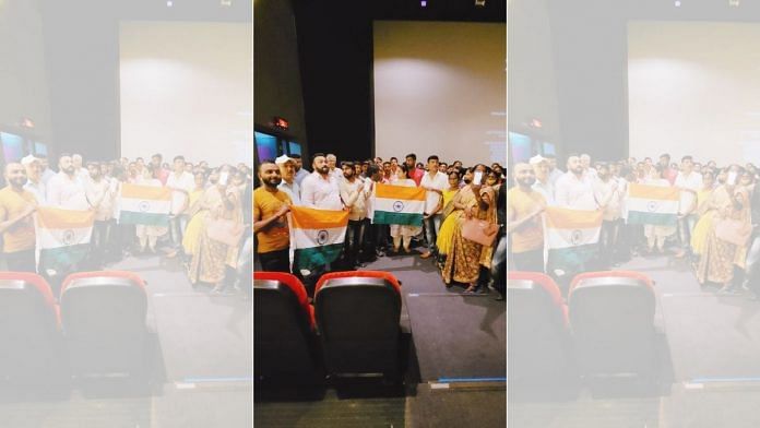 Members of the audience hoisting the tricolour after watching a free screening of ‘The Kashmir Files,’ organised by BJP corporator Renu Hansraj in Mumbai | By special arrangement