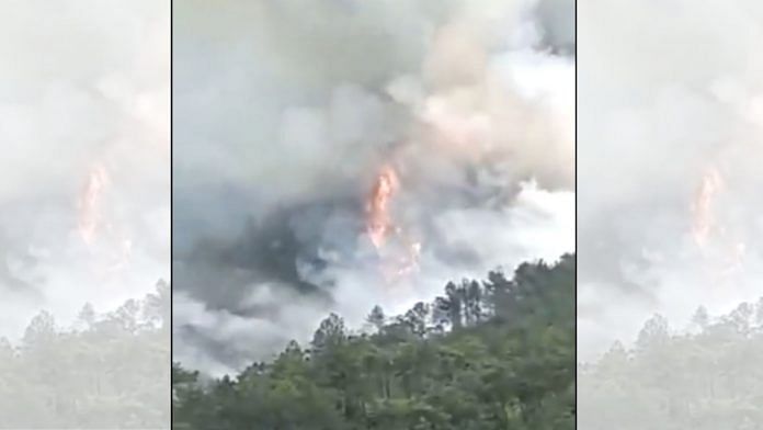 A fire raging at site where the China Eastern Airlines plane crashed in Guangxi on 21 March 2022