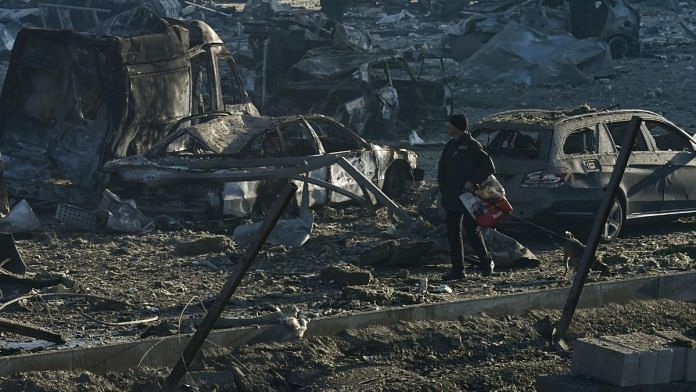 A man walks his dog past burnt out vehicles and debris following a missile attack on the Retroville shopping mall in Kyiv on March 21, 2022 | Representational image| Photographer: Aris Messinis/AFP/Getty Images via Bloomberg