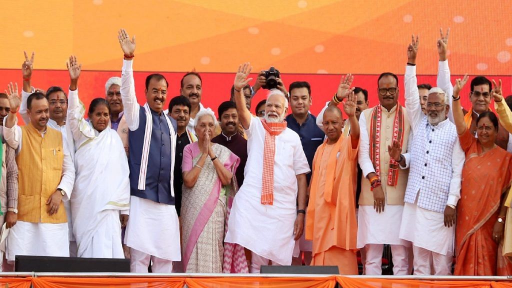 Prime Minister Narendra Modi with Uttar Pradesh Governor Anandiben Patel, Uttar Pradesh CM Yogi Adityanath, and the new cabinet at the swearing-in ceremony in Lucknow Friday | ANI