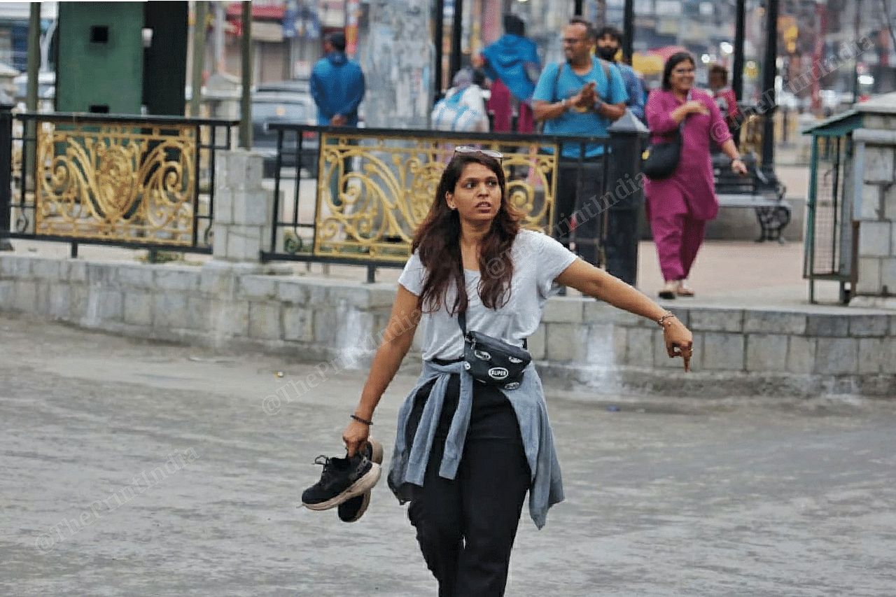 A production crew member from Mumbai unwinds at Lal Chowk | Photo: Praveen Jain | ThePrint