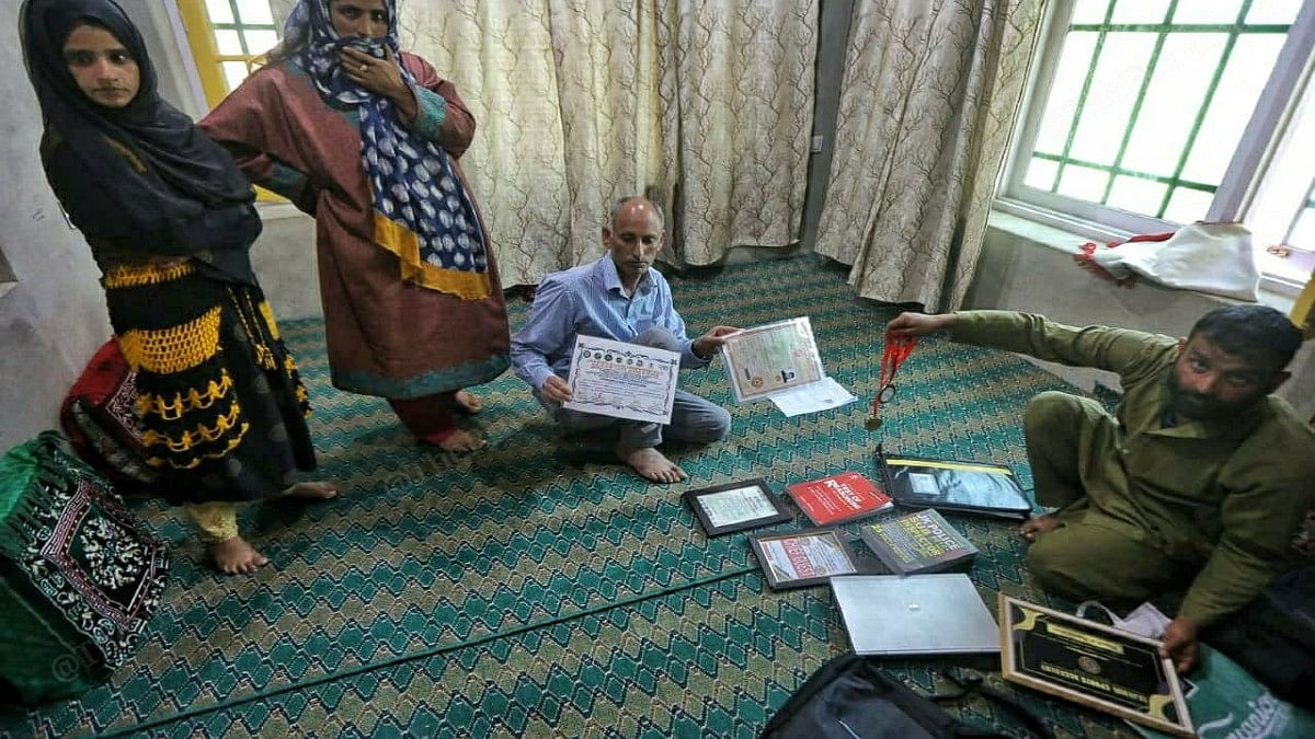 Raja showing Ishfaq’s certificates | Praveen Jain | ThePrint