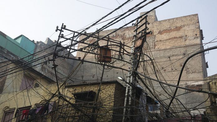 Representational image | Electricity cables hang above a street at Chandni Chowk market in New Delhi | Photo: Ruhani Kaur | Bloomberg