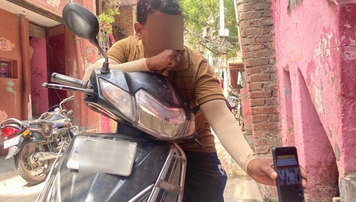 A resident of Jahangirpuri shows the memes on his phone | Vandana Menon/ThePrint