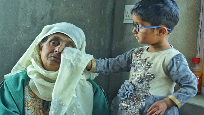 Jana Begum is consoled by a child at her home in Chattabugh village in J&K's Budgam | Praveen Jain | ThePrint