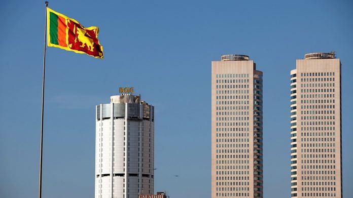 File photo of the Sri Lankan flag in front of the Bank of Ceylon (L) and the World Trade Towers in Colombo | Photo : Prashanth Vishwanathan | Bloomberg