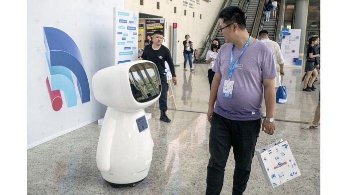 Attendees walk past Baidu Inc.'s Xiaodu robot in Beijing | Representational image | Bloomberg