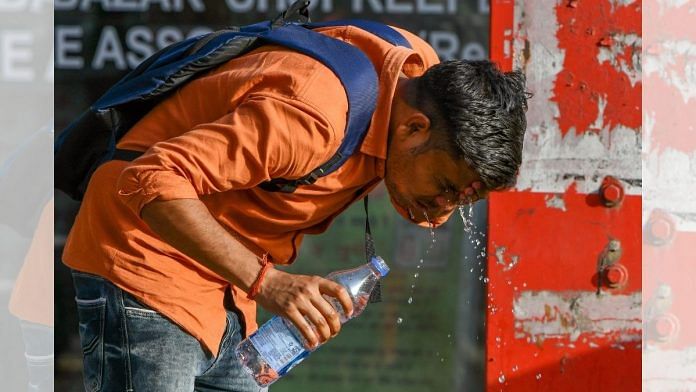 A man takes respite from the heatwave by washing his face in New Delhi, 3 April 2022 | ANI photo