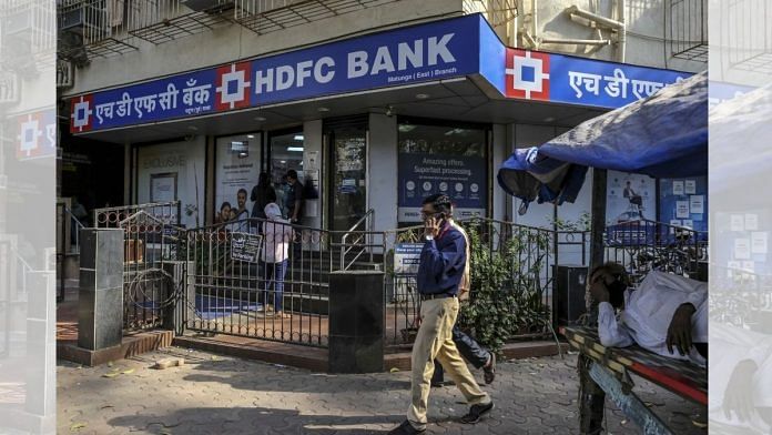 Pedestrian walk past an HDFC Bank branch in Mumbai | Bloomberg file photo