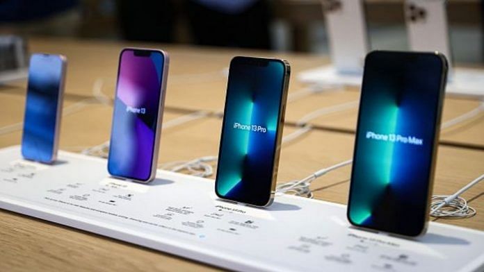 Models of the newly released iPhone 13 are displayed at the Apple Store in Singapore | Photo by Feline Lim/Getty Images via Bloomberg