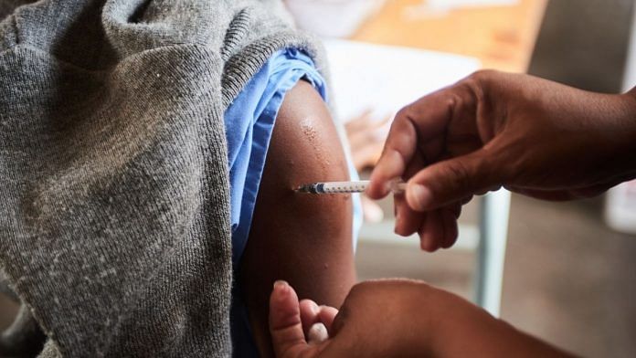 A health worker administers a Covid vaccine to a student in South Africa | Representational image | Bloomberg