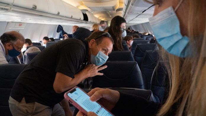 Passengers wearing mask inside an airplane| Representational image| Bloomberg