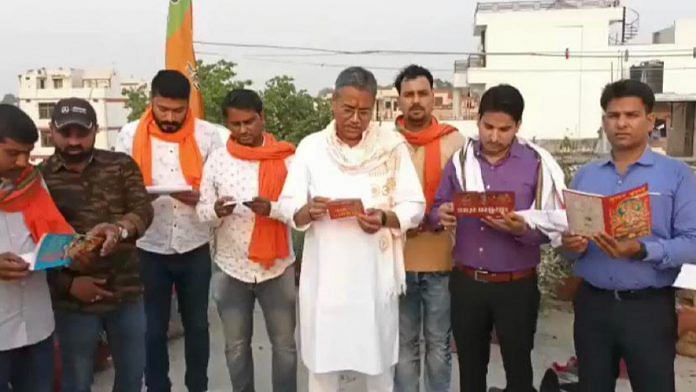 A still from a video of Sudhir Singh and others reciting the Hanuman Chalisa while the hymn plays on a loudspeaker in the background | Twitter
