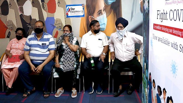 Beneficiaries wait for the precautionary dose of Covid vaccine at a health facility in Delhi | ANI