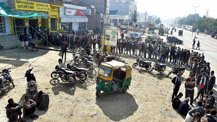 File photo of farmers standing in a queue outside a fertiliser shop to buy urea, in Bikaner | ANI