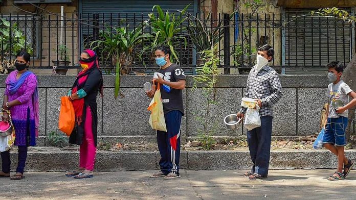 Representational image | People stand in a queue to collect free food during coronavirus lockdown, in Shahpur Jat area of New Delhi in March 2020| PTI