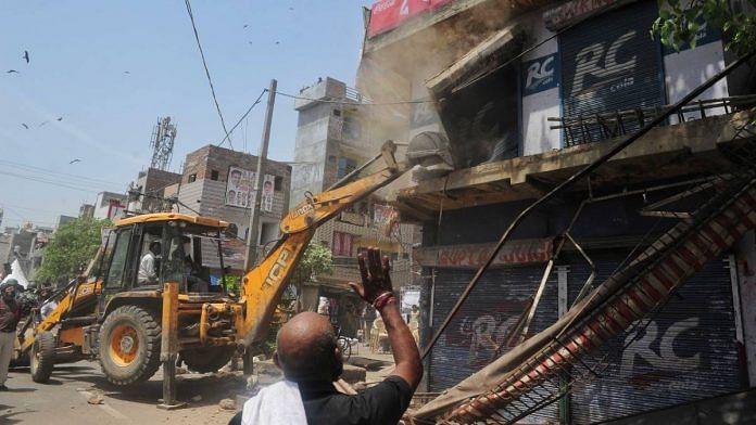 A bulldozer demolishes 'illegal' structures at Delhi's Jahangirpuri on 20 April | Photo: Suraj Singh Bisht | ThePrint