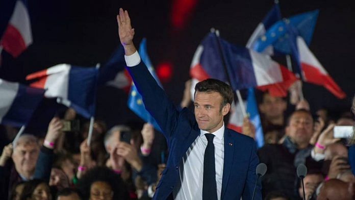 French President Emmanuel Macron waves to supporters following the second round of voting in the French presidential election in Paris on 24 April 2022 | Bloomberg Photo