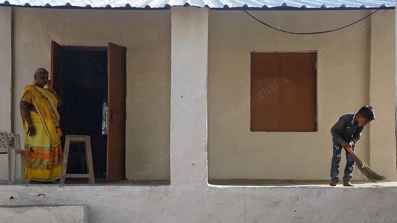 Ushaben Arjunbhai Katara looks on as a student sweeps the veranda at the Mena Varg-I government lower primary school in Batakwada village, Mahisagar district | Manisha Mondal | ThePrint