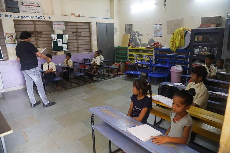 Rajesh Railal Padhariya, principal-cum-teacher at the Shree Shakti Nagar prathmikshala in Kachchh. He has divided the students of various classes into two groups and teaches each turn by turn | Manisha Mondal | ThePrint